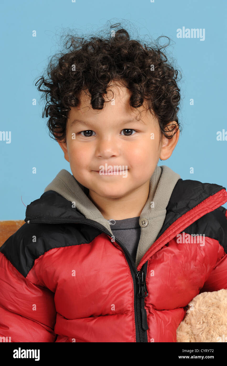 portrait of a little brazilian boy, on blue background Stock Photo