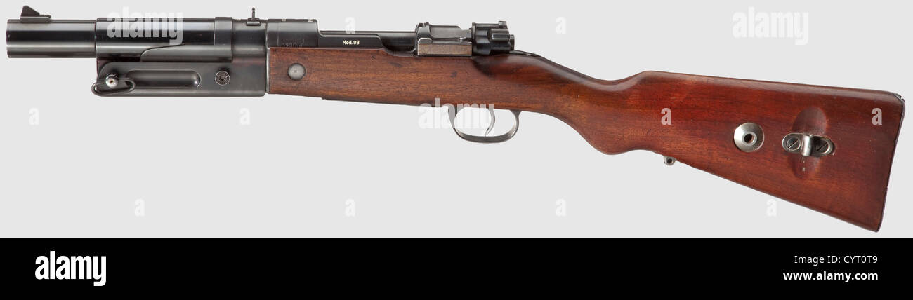 Sturmkampfgewehr(StKG)/ Assault Battle Rifle,coded 'dva',Cal. 4,no. 1290a. Bright,smooth drop barrel,length 160 mm. Total length 730 mm. Converted from Karabiner 98 k coded 'dot 1943' and an early stock by Kugelfischer,Schweinfurt with code 'dva' on a smooth bore for firing 2.6 cm 326 LP mortar shell cartridges.(One discharged blasting charge 326 is included.)On right side of receiver head marked “St K Gö. Fixed sight. Modified,non-removable breech. Refinished. Walnut stock. Comes with a rifled sub-calibre bore,length 160 mm,with cap nut to lock 17,Additional-Rights-Clearences-Not Available Stock Photo