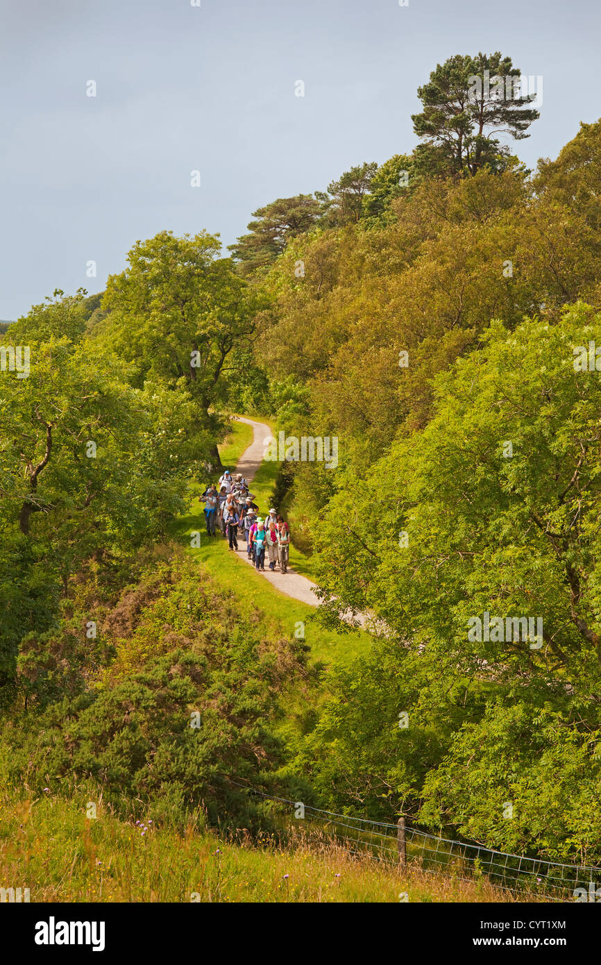 Walkers on the Greenock Cut approaching the visitor centre at Cornalees Bridge Stock Photo