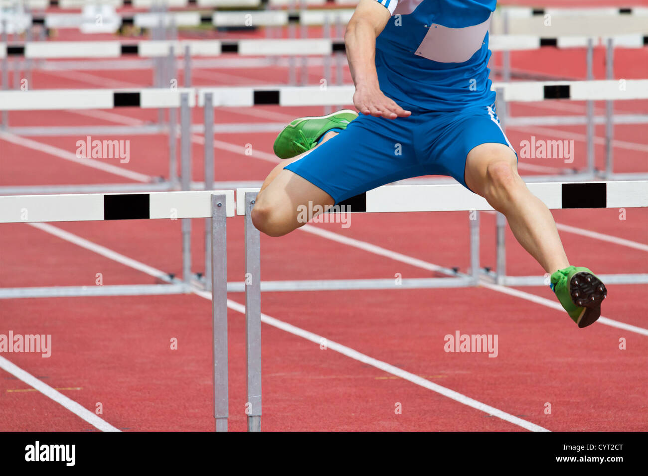 hurdle runner leaping over the hurdles Stock Photo