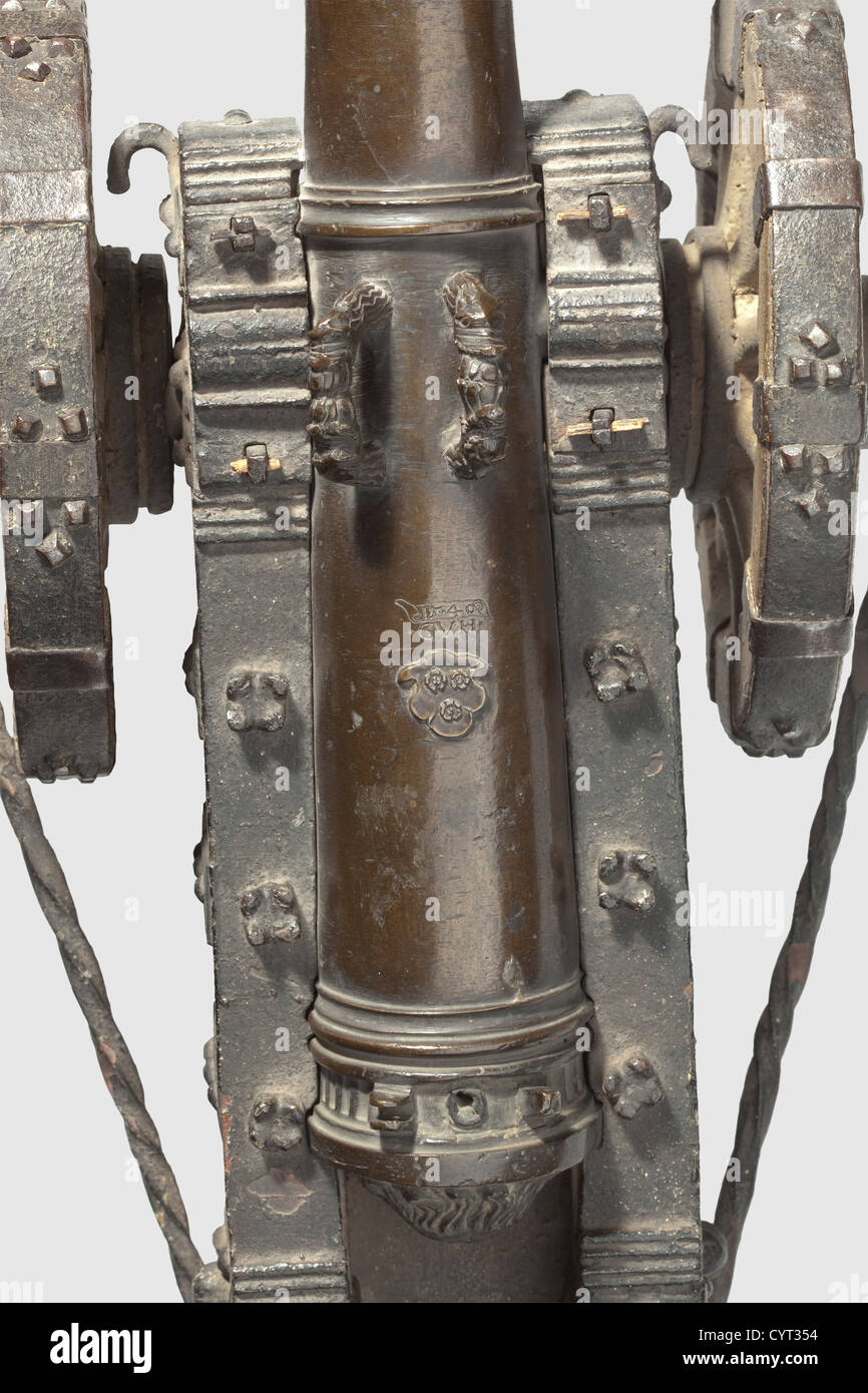 Model of a 'Feldschlange'(gun),German,dated 1540. Heavy,tapering bronze barrel with heavily reinforced muzzle. Smooth bore in 18 mm calibre. Lateral trunnions,handle in shape of double dolphin heads. On upper side applied arms with three roses and engraving '1540 CVH'. No touchhole cover,recoil plate with lionïs head in half relief. Original,coloured wooden carriage with finely forged iron mountings. Barrel length 48.5 cm,total length 80.5 cm. Rare and extremely early model cannon in beautiful untouched original condition,historic,historical,16th cen,Additional-Rights-Clearences-Not Available Stock Photo