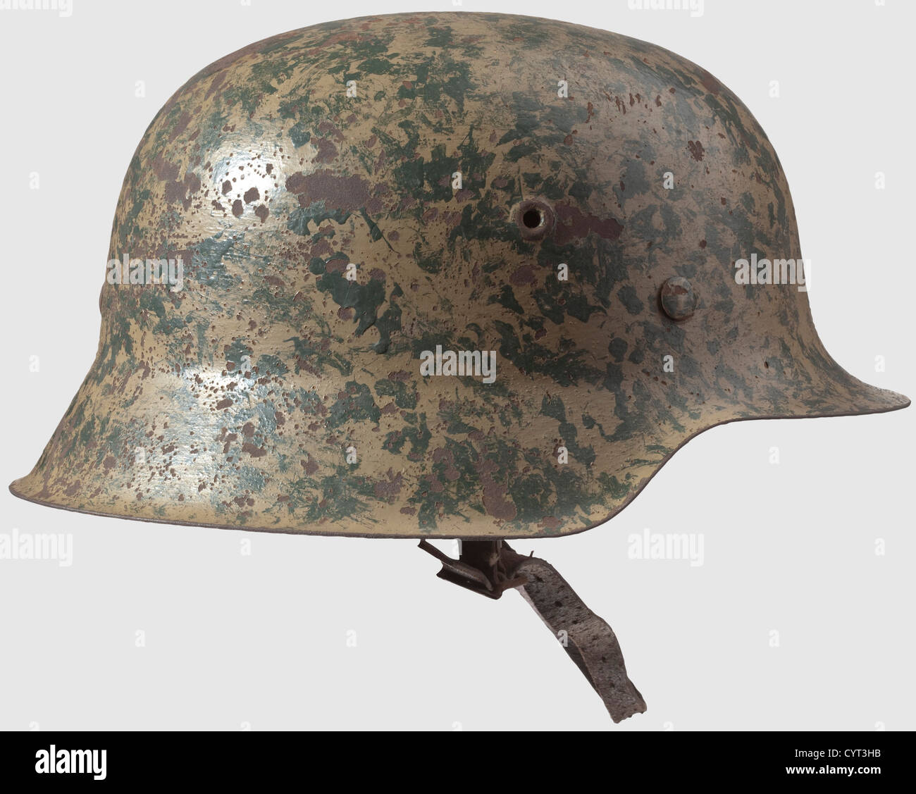 A M 42 steel helmet,Afrika Korps - Luftwaffe Muli-colour original finish in  desert camouflage,with Luftwaffe eagle. Ventilation holes  punched-in,un-flanged edge,complete with inner liner and chin strap. The  nape stamped "1532",the inner liner
