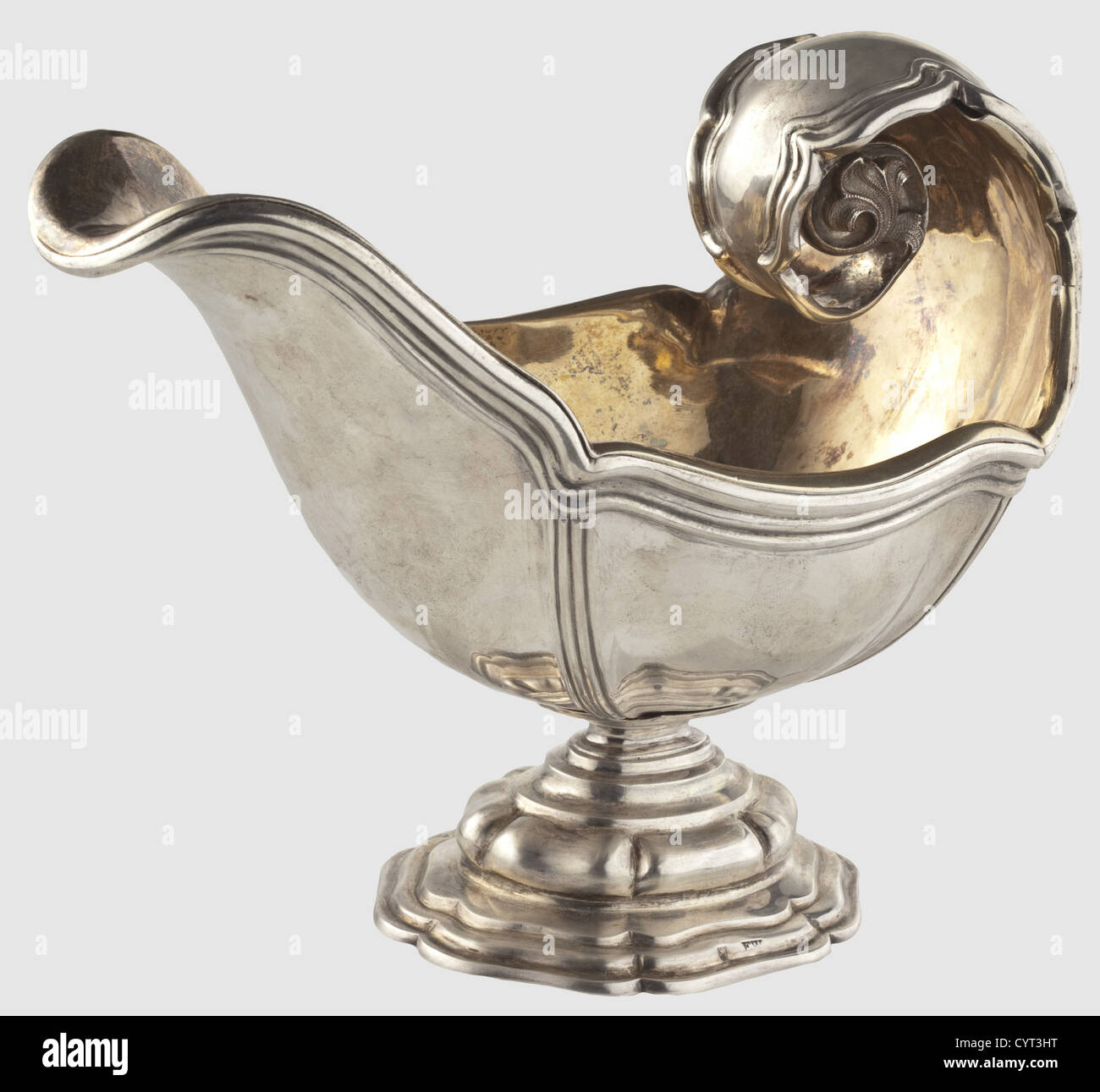 King Ludwig II of Bavaria(1845 - 1886),a silver sauce boat from the King's table service By Court Jeweller Eduard Wollenweber,Munich around 1870/80.Silver with triple banded rim decoration and an incurved handle stamped with decorative leaves.There is a mirror monogram 'L' beneath a Bavarian royal crown,resembling the monogram of the Sun King Louis XIV,engraved on the back of the grip.Gilt silver,turned under insert(loose at one point).'Wollenweber' masters mark and the 'Münchner Kindl' hallmark.The stepped base is marked 'E.W.' and has another City,Additional-Rights-Clearences-Not Available Stock Photo