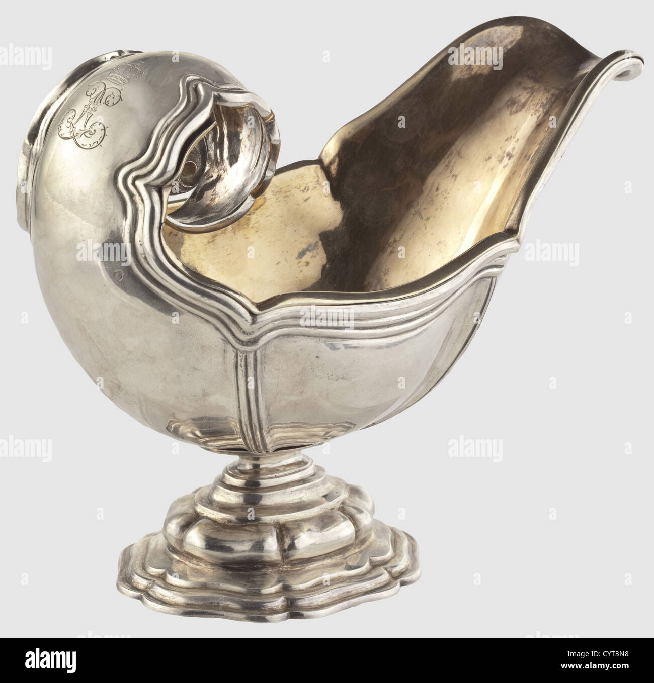 King Ludwig II of Bavaria(1845 - 1886),a silver sauce boat from the King's table service By Court Jeweller Eduard Wollenweber,Munich around 1870/80.Silver with triple banded rim decoration and an incurved handle stamped with decorative leaves.There is a mirror monogram 'L' beneath a Bavarian royal crown,resembling the monogram of the Sun King Louis XIV,engraved on the back of the grip.Gilt silver,turned under insert(loose at one point).'Wollenweber' masters mark and the 'Münchner Kindl' hallmark.The stepped base is marked 'E.W.' and has another City,Additional-Rights-Clearences-Not Available Stock Photo