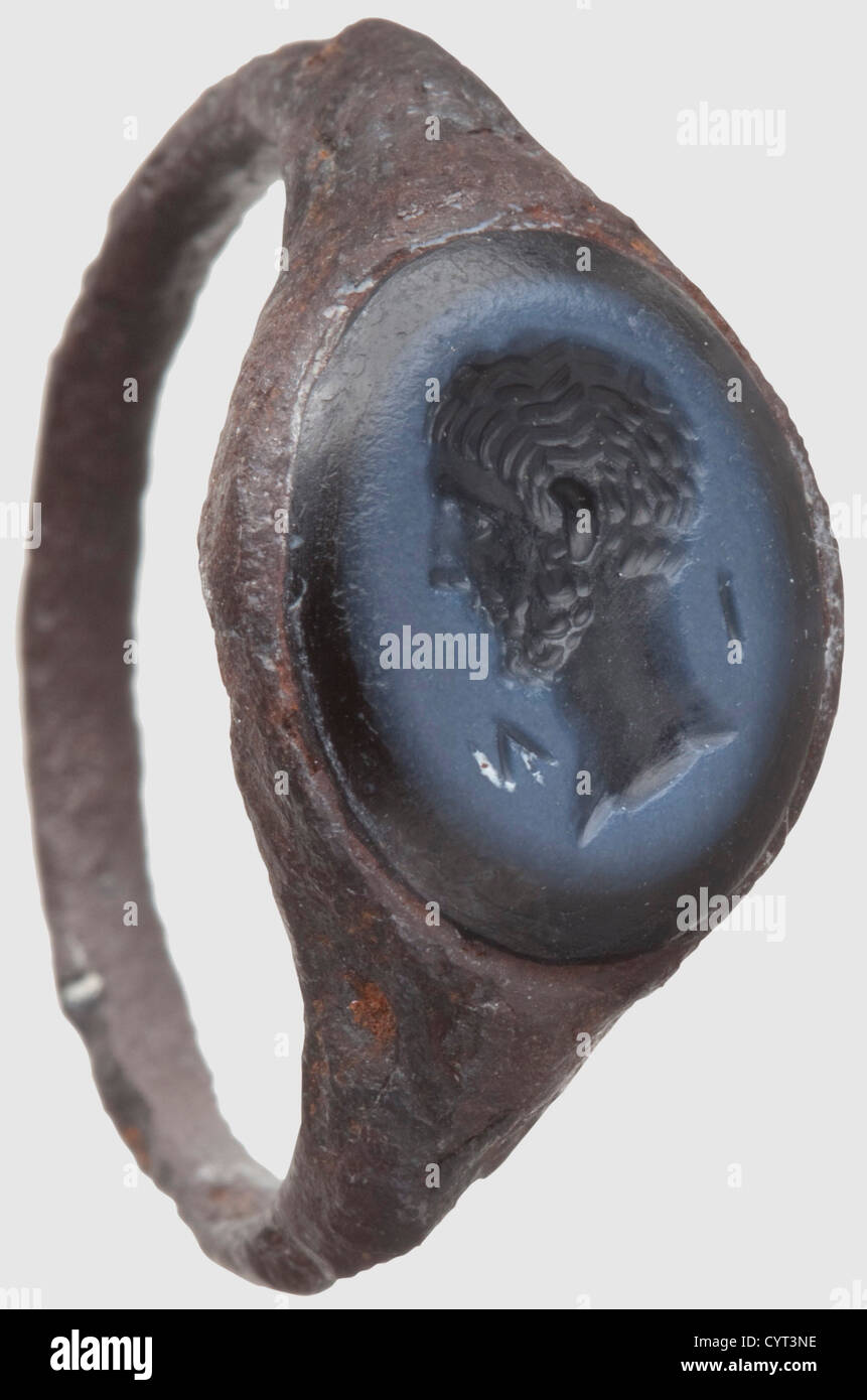 A Roman iron ring with an intaglio of Octavian,1st half of the 1st century AD. Narrow iron band tapering to a wider face with a blue Uruguay agate within an oval setting. There is a deeply cut of Octavian's head,inscribed 'I M' on each side of the neck. Height 2.4 cm. Iron band corroded. Provenance: Private collection in southern Germany,acquired in the 70s and later. ,historic,historical,people,ancient world,ancient world,ancient times,object,objects,stills,clipping,cut out,cut-out,cut-outs,mediterranean,precious metal,precious metals,jewel,Additional-Rights-Clearences-Not Available Stock Photo