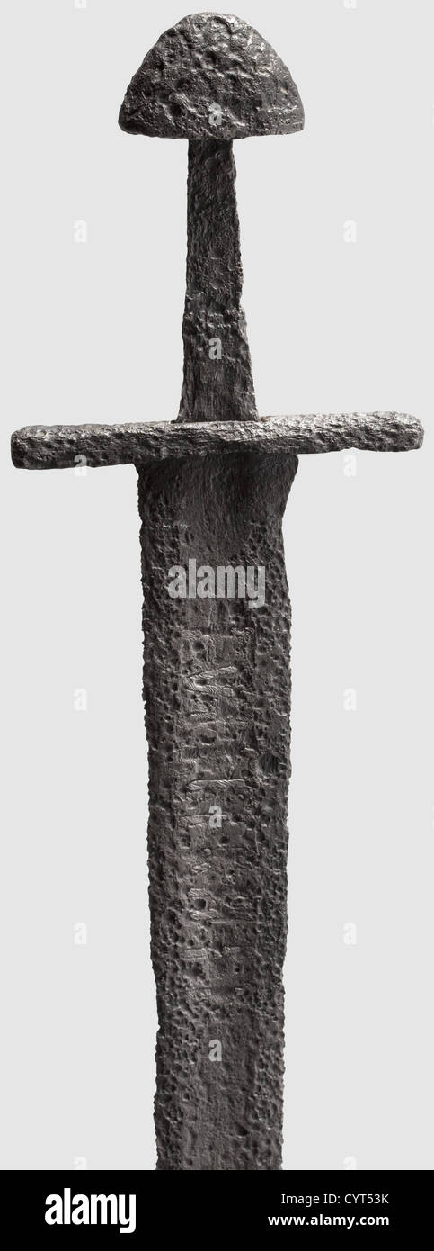 An inscribed sword,2nd Half of the 11th Century Slender blade with a wide fuller on either side,one containing an almost illegible inscription inlaid in iron '+VLFBEHR+T'(?). Short heavy quillons with quadrangular cross-section,narrow tang and a mushroom pommel. Length: 97 cm. The name inscription,'Ulfbehrt'(with variants)presumably refers to a Frankish smith of the 8th century on the Lower Rhine,whose swords were so highly regarded that his name soon became a sort of trademark,historic,historical,11th century,sword,swords,weapons,arms,weapon,a,Additional-Rights-Clearences-Not Available Stock Photo