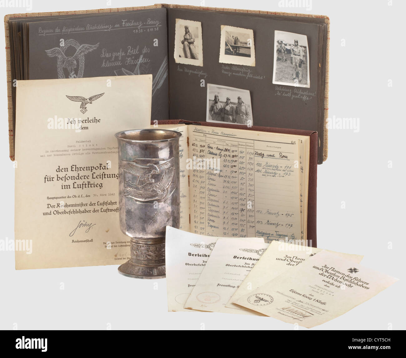 Legacy of pilot Gustl Sticht,a goblet of honour,certificates,a photo album,and a logbook of the 'Westa 26'(the 26th weather recoinnaissance squadron)A goblet of honour for outstanding achievement in the air war,the Alpaka version,engraved,'Feldwebel Gustl Sticht am 30.3.42'(Sergeant 1st Class Gustl Sticht on 30 March 1942). Height 20.8 cm,slightly dented at the base. Certificates for the honour goblet on 30 March 1942 for success as a weather service pilot,for the Iron Cross 1939,both 2nd and 1st Class,while with the 26th weather reconnaissance sq,Additional-Rights-Clearences-Not Available Stock Photo