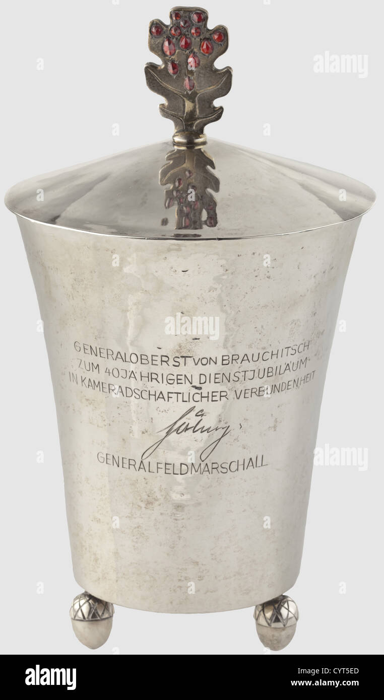 Walther von Brauchitsch,a silver beaker,a gift from Hermann Göring 1940 Cup and cover,the standing oak leaf decorated with a garnet set à jour.The surface with visible hammer marks,three feet in the form of acorns(one damaged),the exterior with engraved gift inscription "Generaloberst von Brauchitsch zum 40jährigen Dienstjubiläum in kameradschaftlicher Verbundenheit - Göring - Generalfeldmarschall"("To Generaloberst von Brauchitsch,for 40 years of service in solidarity - Göring - Generalfeldmarschall").Signature and mark of the famous silversmith Prof,Additional-Rights-Clearences-Not Available Stock Photo