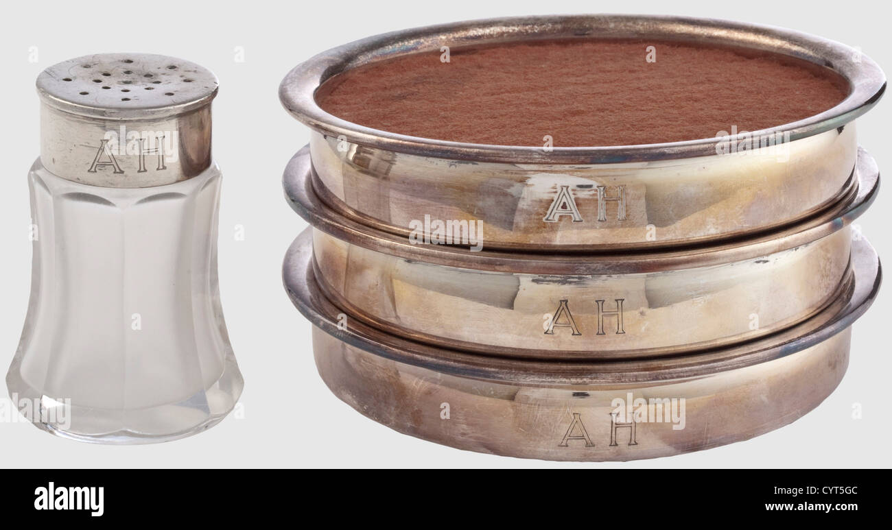 Adolf Hitler,three coasters for wine bottles Hard silver plating. Flared rims,dark red felt inlays,the obverse with the engraved owner's initials 'AH',maker's mark 'Wellner',diameter each 10.4 cm. Also a salt shaker(damaged)with silver plated cap,also by Wellner,height 6 cm. Cf. Hermann Historica,59th auction,15 April 2010,lots 7228/7229. Provenance: Keith Wilson Collection,Kansas City. Very rare pieces of Adolf Hitler's personal silver tableware,historic,historical,1930s,1930s,20th century,NS,National Socialism,Nazism,Third Reich,German ,Additional-Rights-Clearences-Not Available Stock Photo