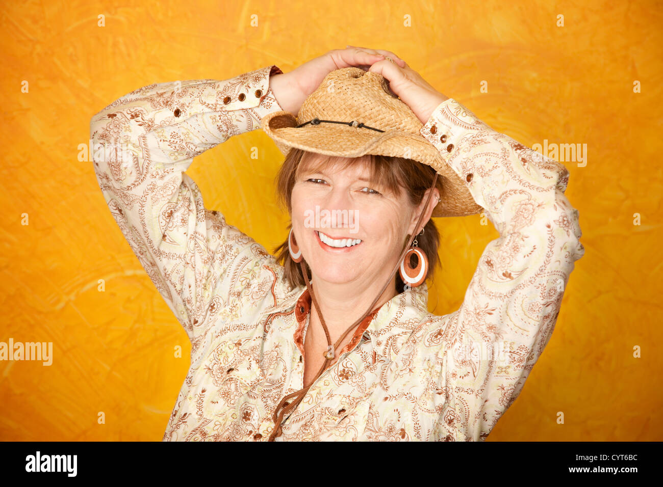 Pretty western woman in cowboy shirt and hat Stock Photo - Alamy