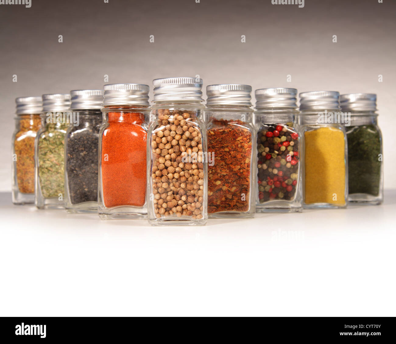 Bottles of colorful spices with grey background Stock Photo - Alamy