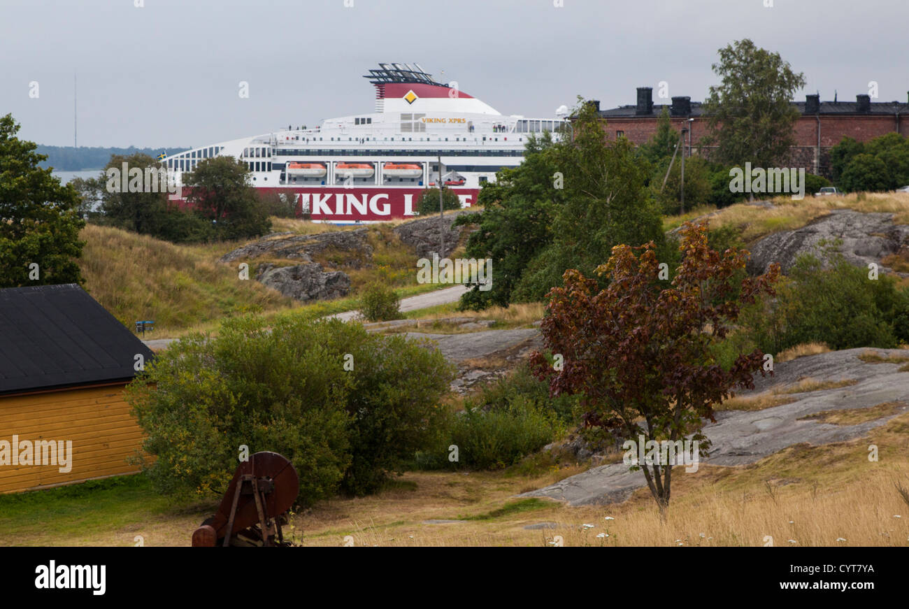 A Viking Line ferry boat passing by Suomenlinna, a Finnish sea fortress that spans 6 islands and was built in 1748 by Sweden Stock Photo