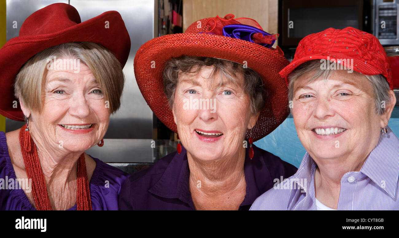 Three friendly senior women wearing red hats Stock Photo Alamy