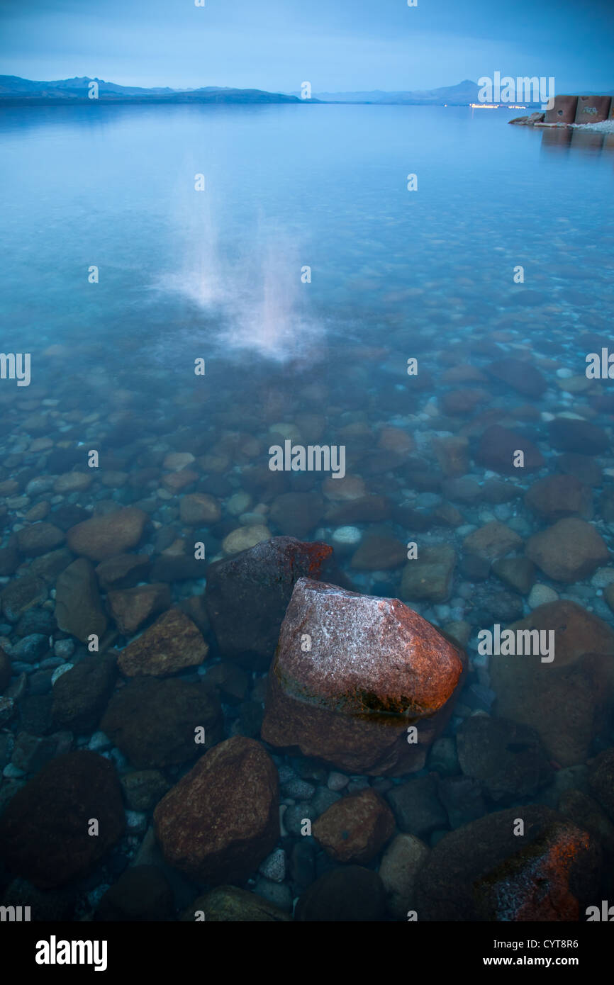 Two splashes from rocks in a lake at dusk. Stock Photo