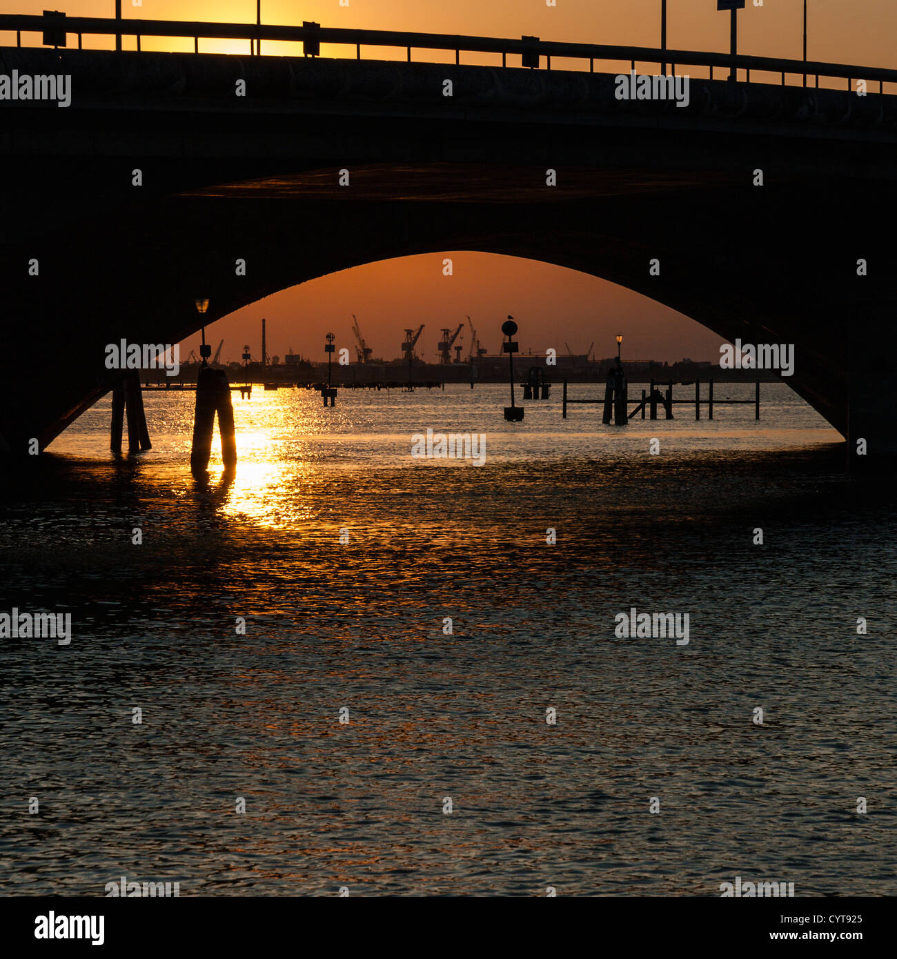 Sunset mirrored under bridge in Venice sea Stock Photo - Alamy