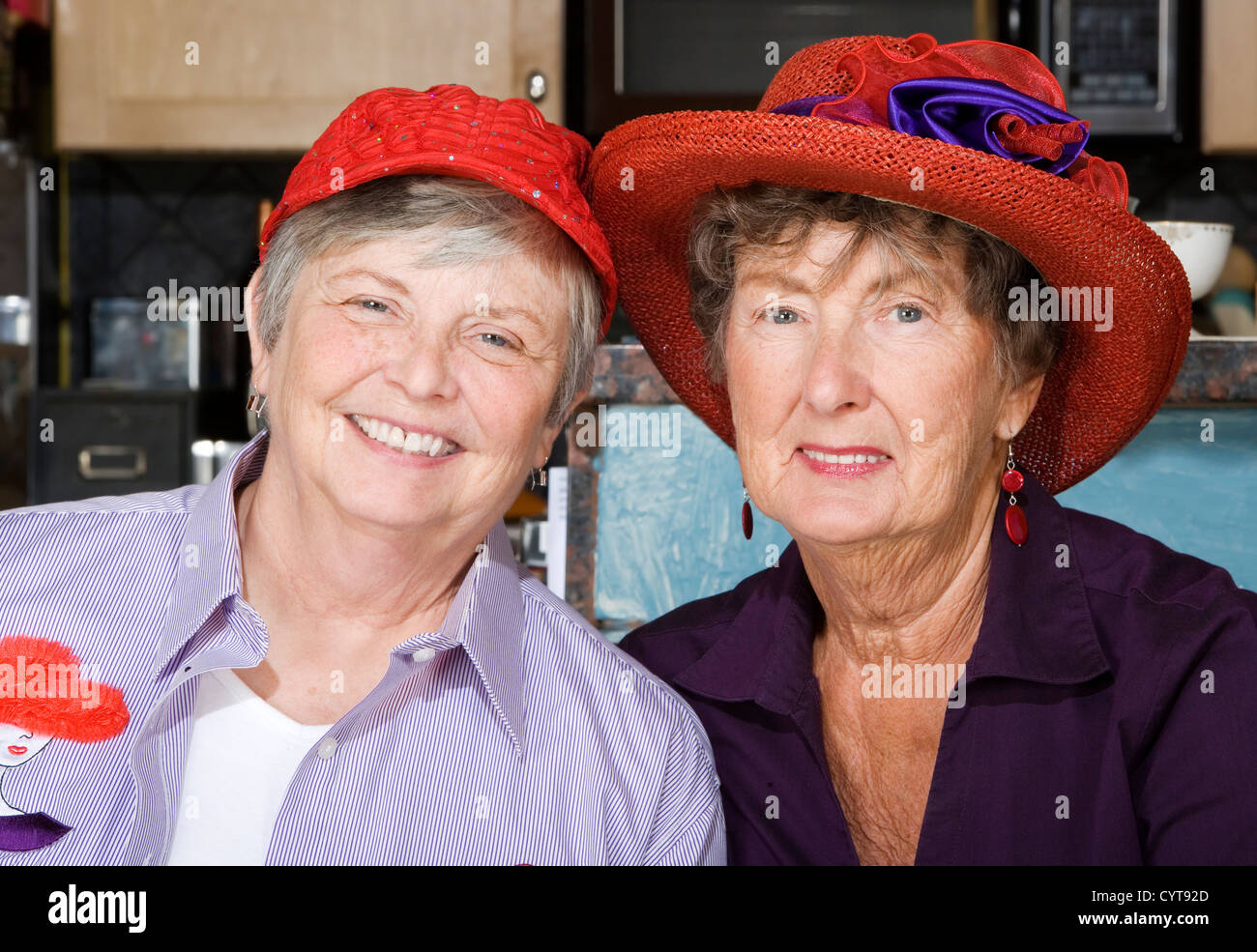 Two friendly senior women wearing red hats Stock Photo Alamy