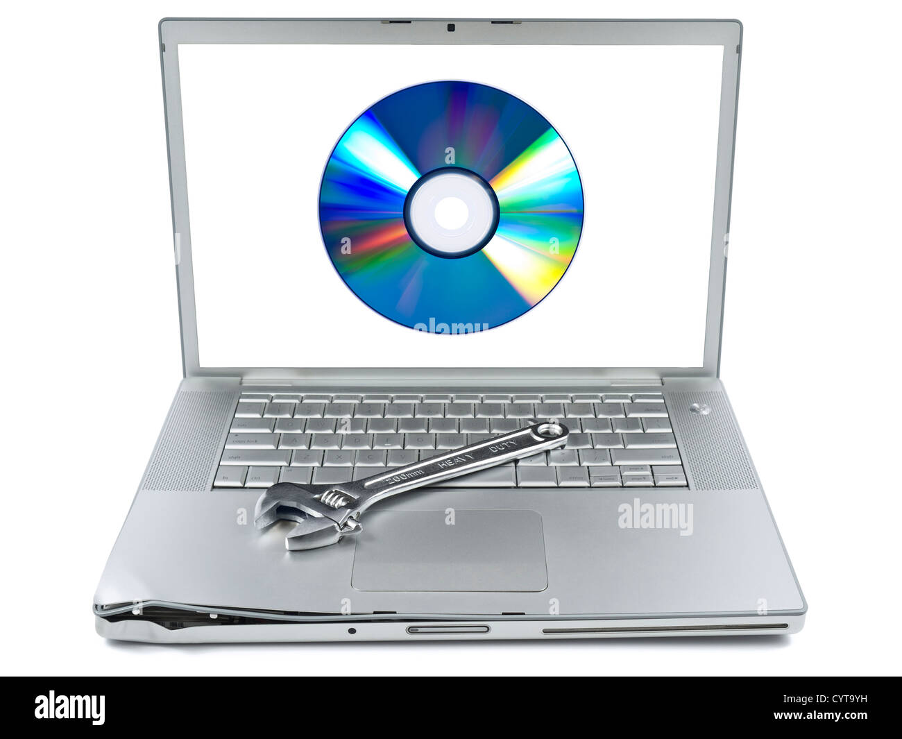 Damaged laptop with a spanner over it and a digital disc on the screen. Isolated on white. Stock Photo