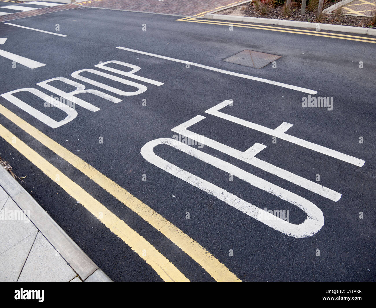 Drop Off sign road marking at a hospital to indicate a short term vehicle stopping place Stock Photo