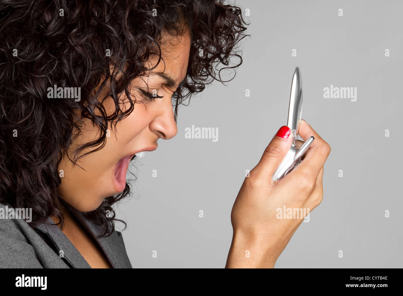 Woman Yelling Into Phone Stock Photo