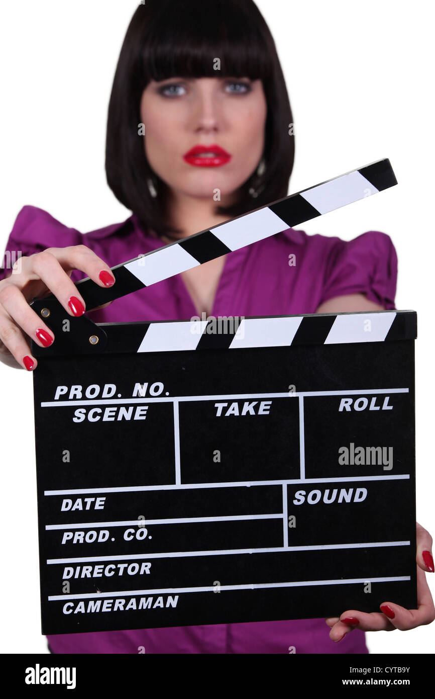 Woman holding up a clapperboard Stock Photo