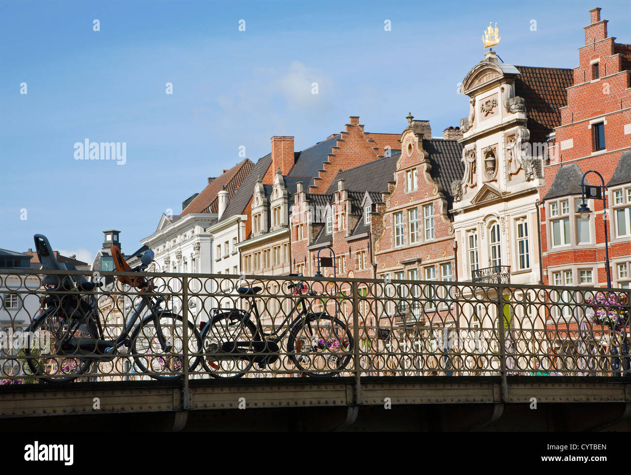Ghent - bicycle on the bridge and typical brick houses in morning light Stock Photo