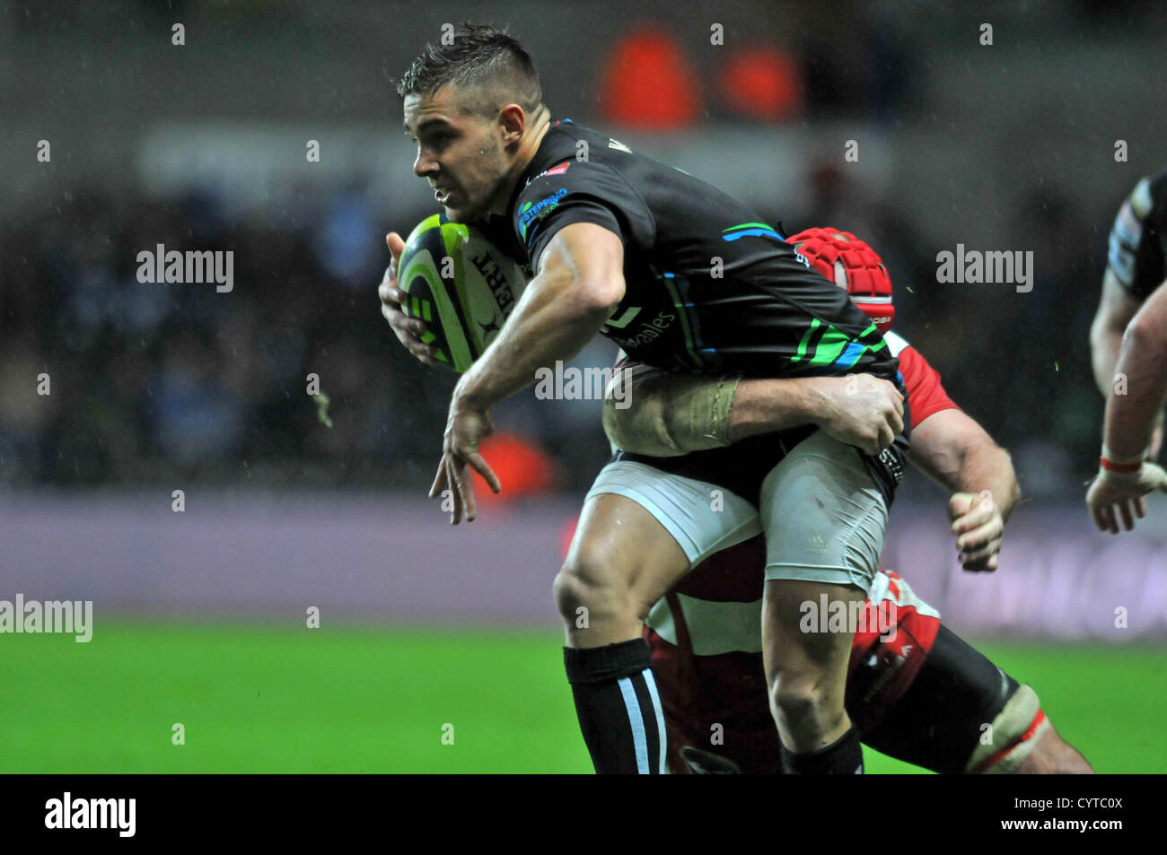 Ospreys v Gloucester - LV=Cup - Swansea - 9th Nov 2012 : Rhys Webb  of the Ospreys is tackled by Peter Buxton the Gloucester Captain. Stock Photo