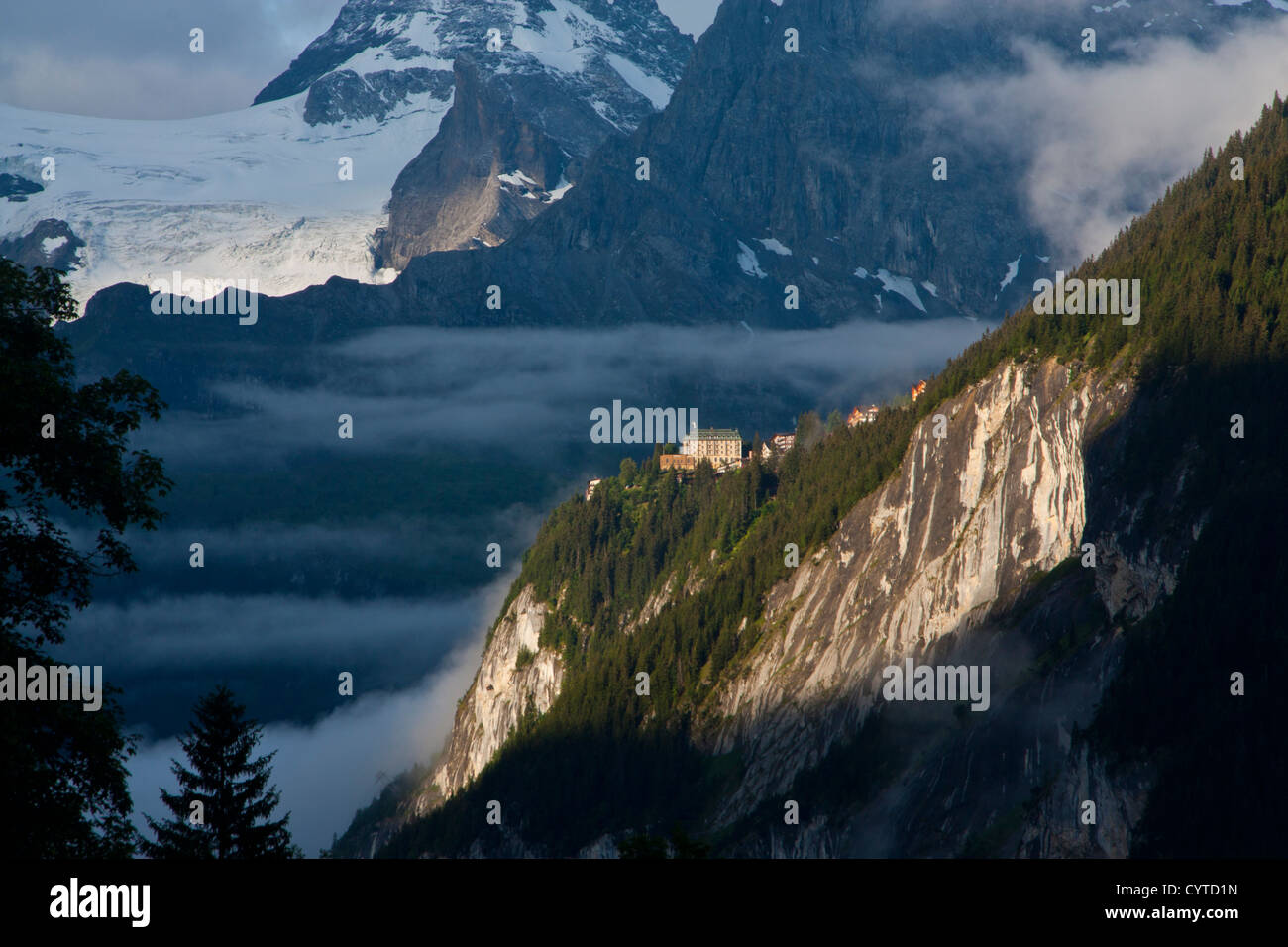 Murren village in morning mist above Lauterbrunnen valley with snowy ...