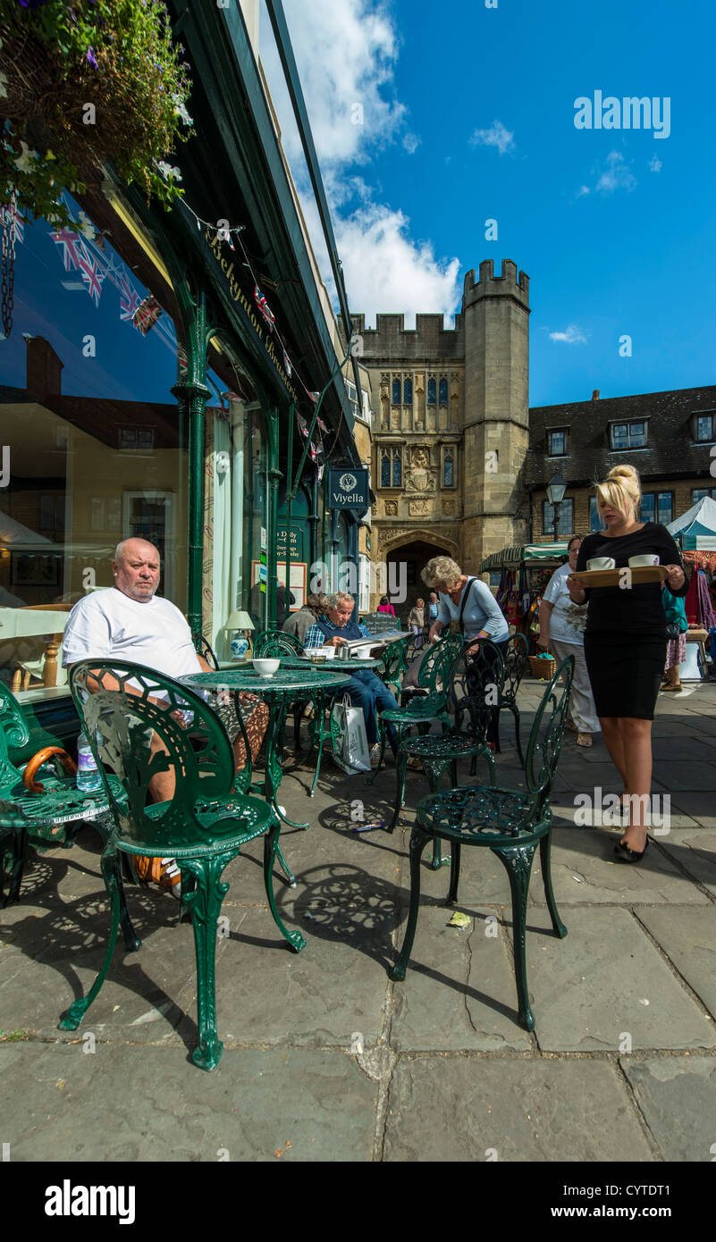 Wells, Somerset, England. September 19th 2012. A waitress serves afternoon tea at the market square in the city of Wells. Stock Photo