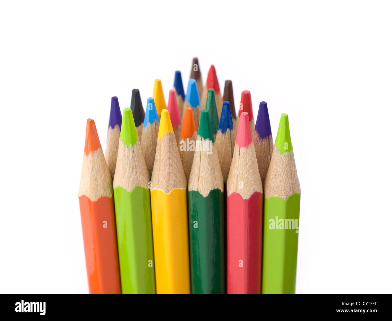 Several colored pencils stand together forming a triangle shape. Stock Photo