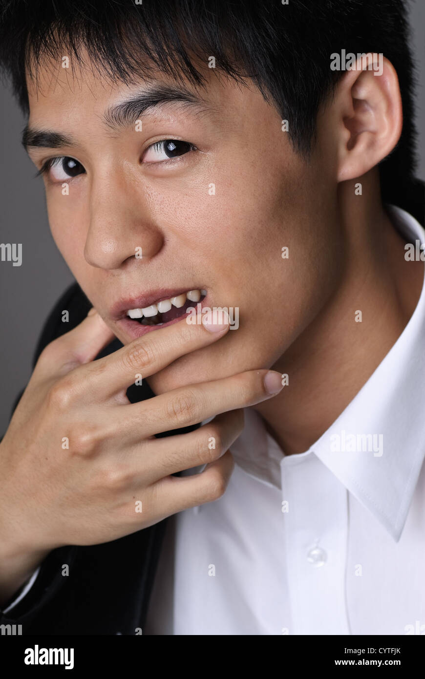Deceitful businessman face, closeup portrait of Asian man Stock Photo ...