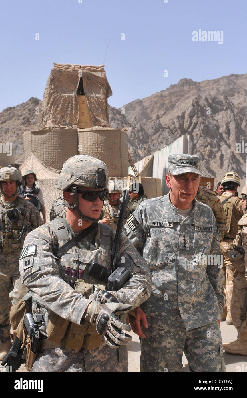 US General David H. Petraeus, commander of NATO and International Security Assistance Force chats with Captain Scott Haran of the 82nd Airborne Division July 9, 2010 in Kandahar, Afghanistan.  Petraeus resigned as Director of the CIA on November 9, 2012 after issuing a statement saying that he had engaged in an extramarital affair. Stock Photo