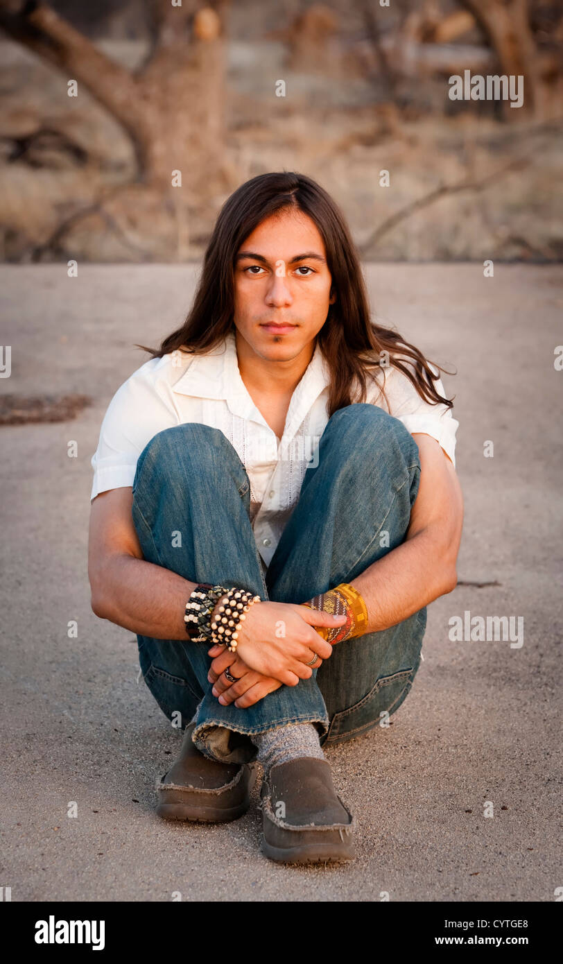 Handsome young man with long hair in an outdoor setting Stock Photo - Alamy