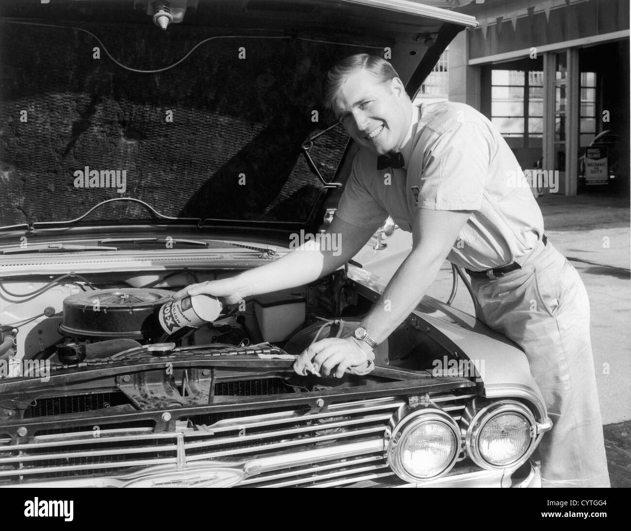 Service man replacing oil in car Stock Photo