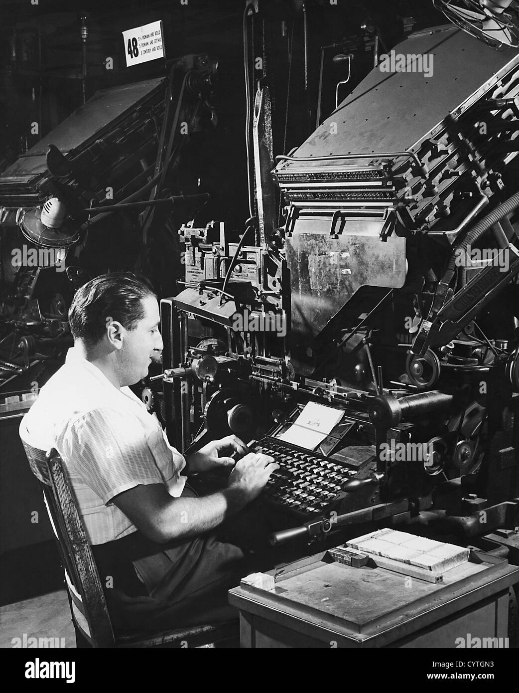 Typesetting machine operator at machine Stock Photo