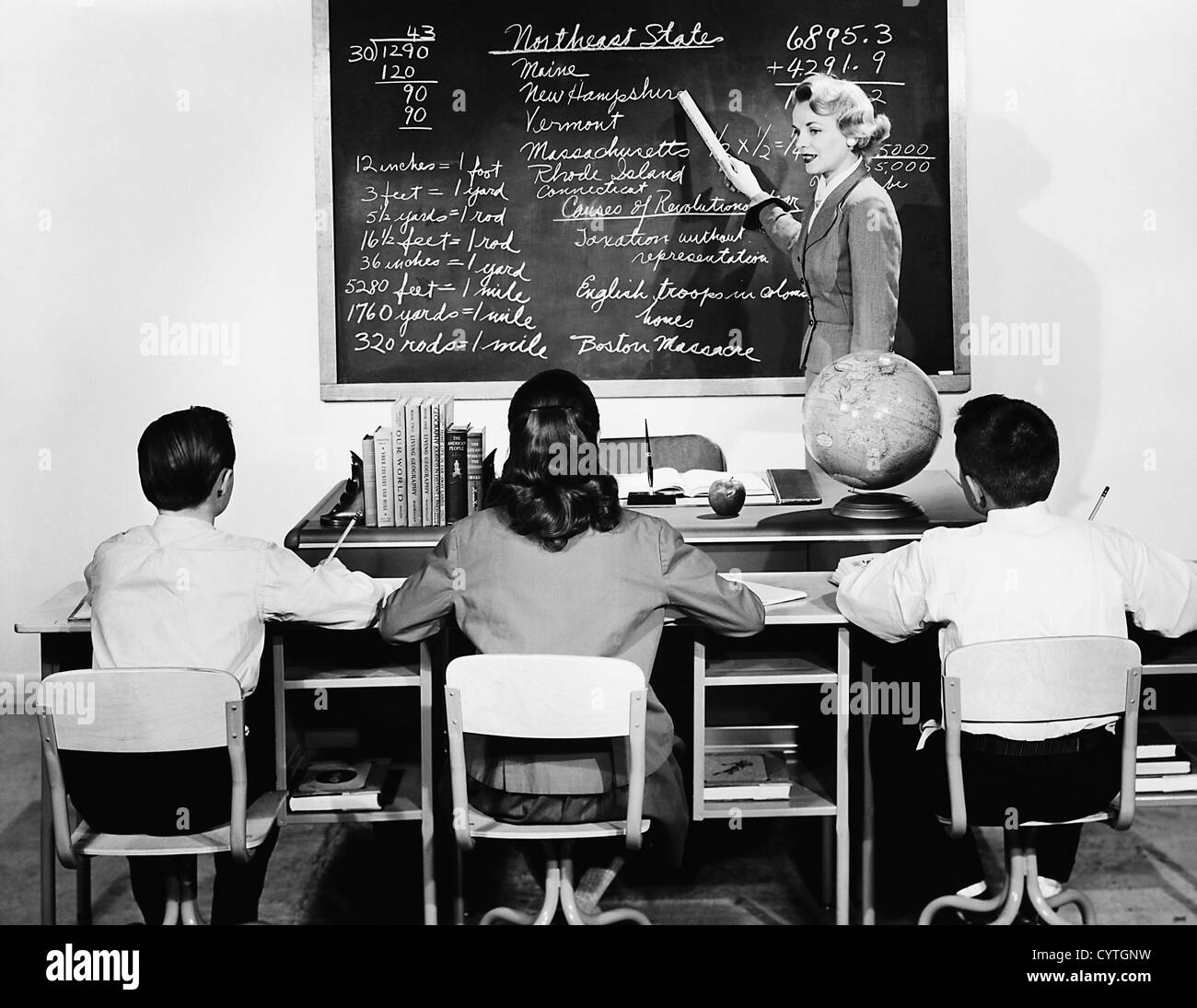 Teacher addressing students in classroom Stock Photo