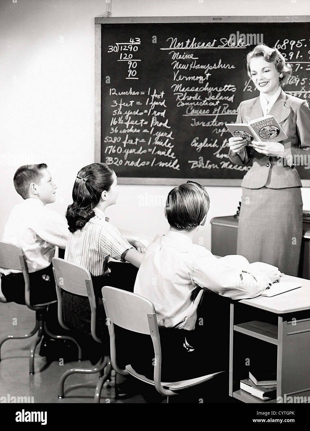 Teacher giving students a lesson in spelling Stock Photo