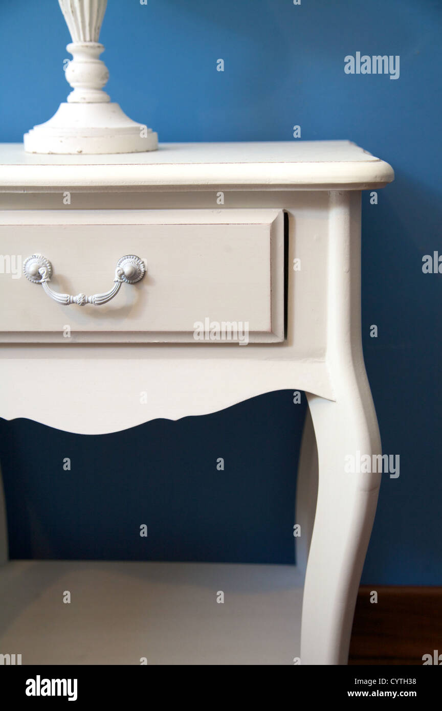 white bedside table and lamp with blue lampshade Stock Photo Alamy