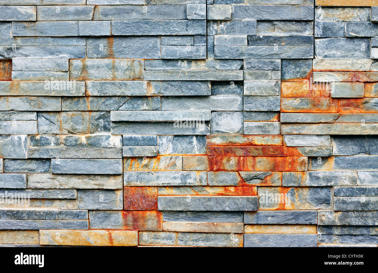 A wall made from stacks of shale rock. great background, texture or wallpaper. Stock Photo
