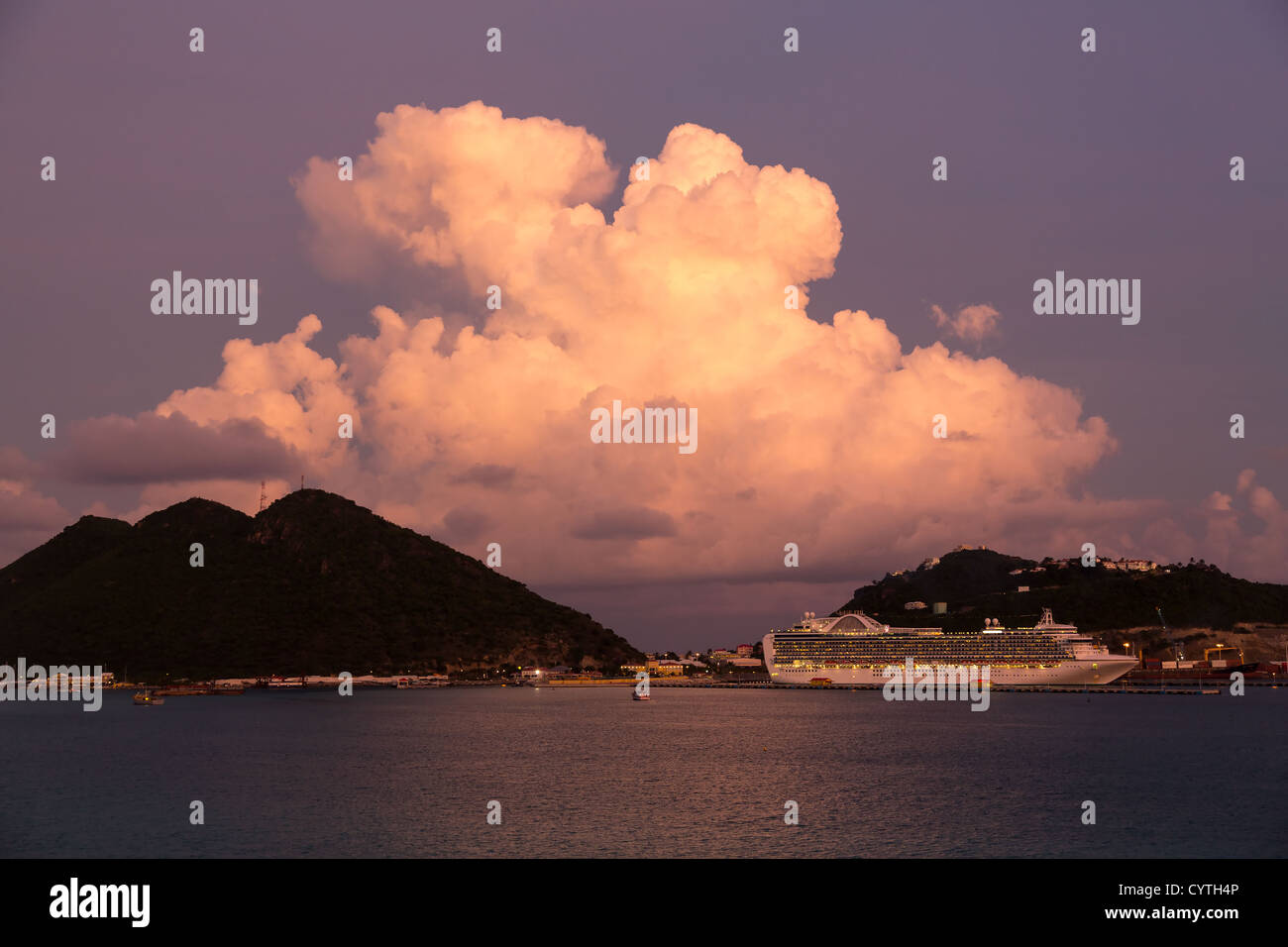 Dramatic evening sunset image of cruise ship in town of Philipsburg in Sint Maarten or Saint St. Martin in Caribbean Stock Photo