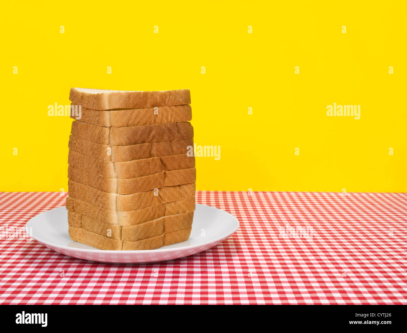 Sliced loaf of bread served on a table. Copy space on the right. Stock Photo