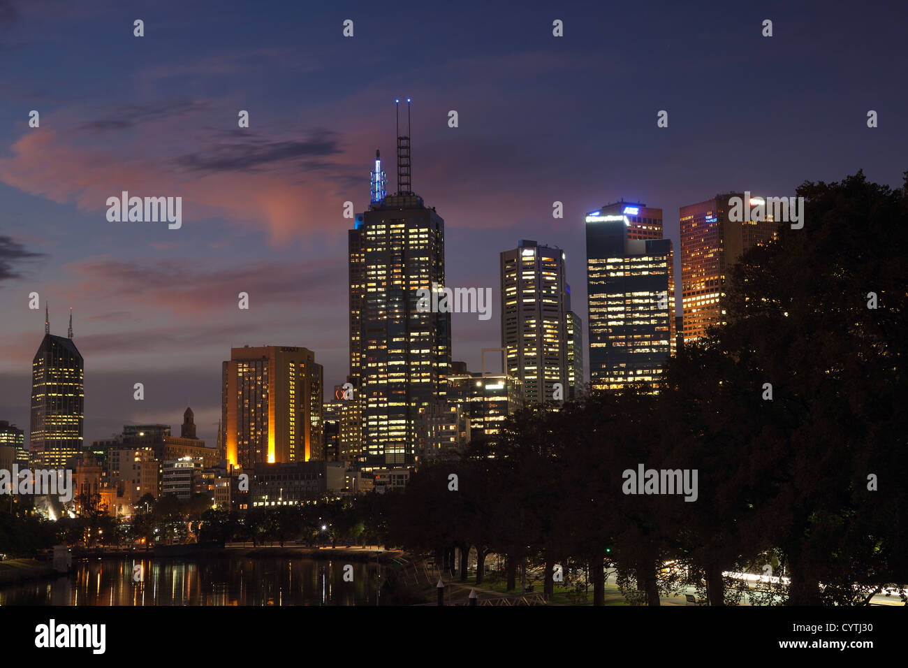 Australia, Melbourne city skyline along the Yarra river at night with buildings lights and purple blue evening sky. Stock Photo