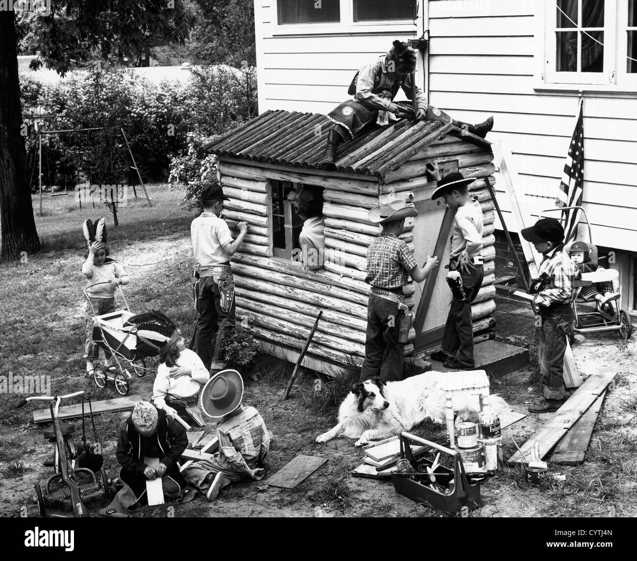 Boys and girls fixing a fort outside their house Stock Photo