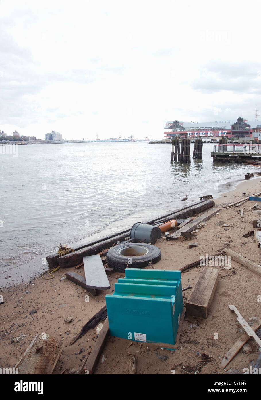 Debris that's washed up on the shore of the East River following flooding from Superstorm Sandy in Manhattan, NYC. Stock Photo