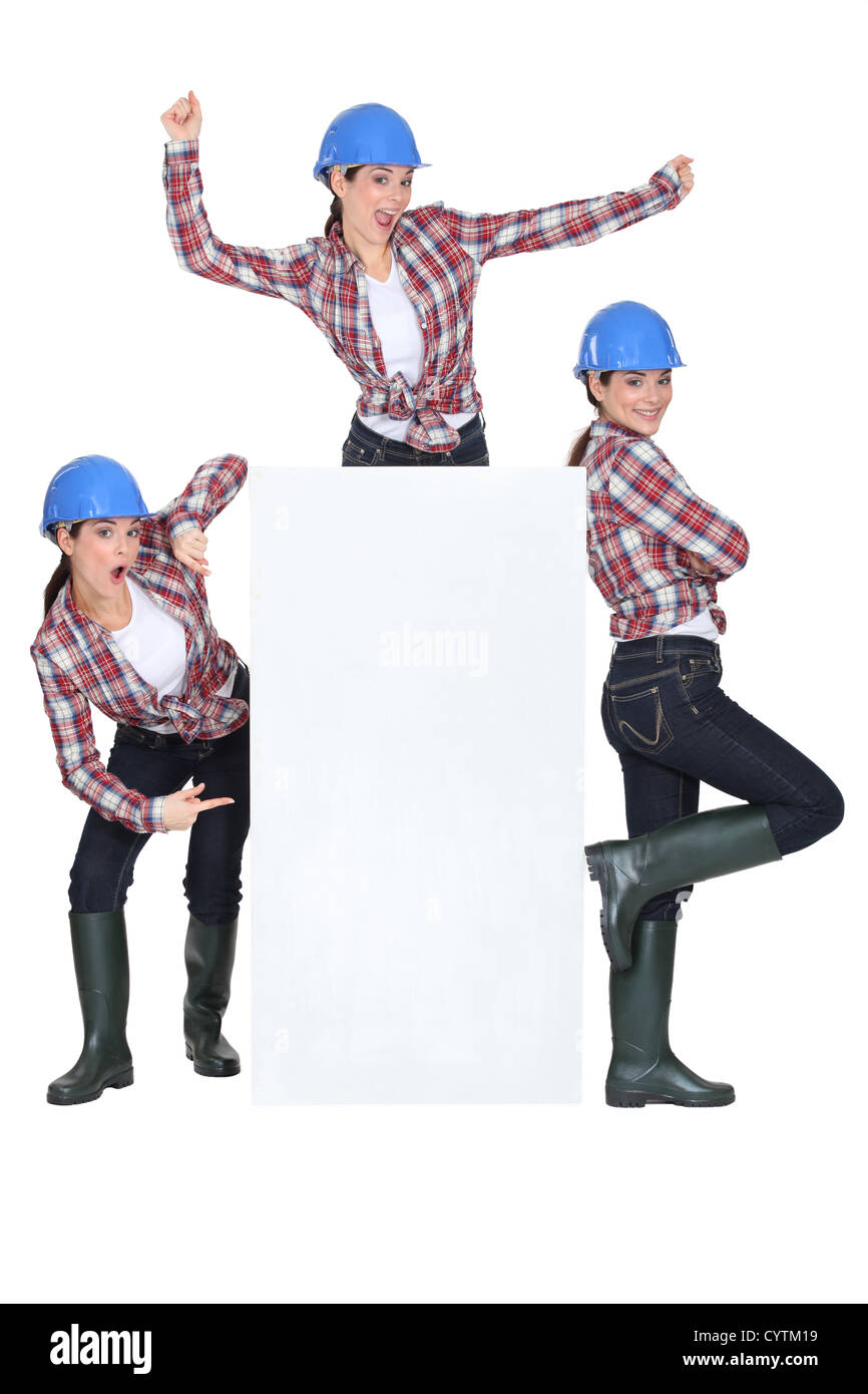 trio of girls wearing blue hard hat Stock Photo Alamy
