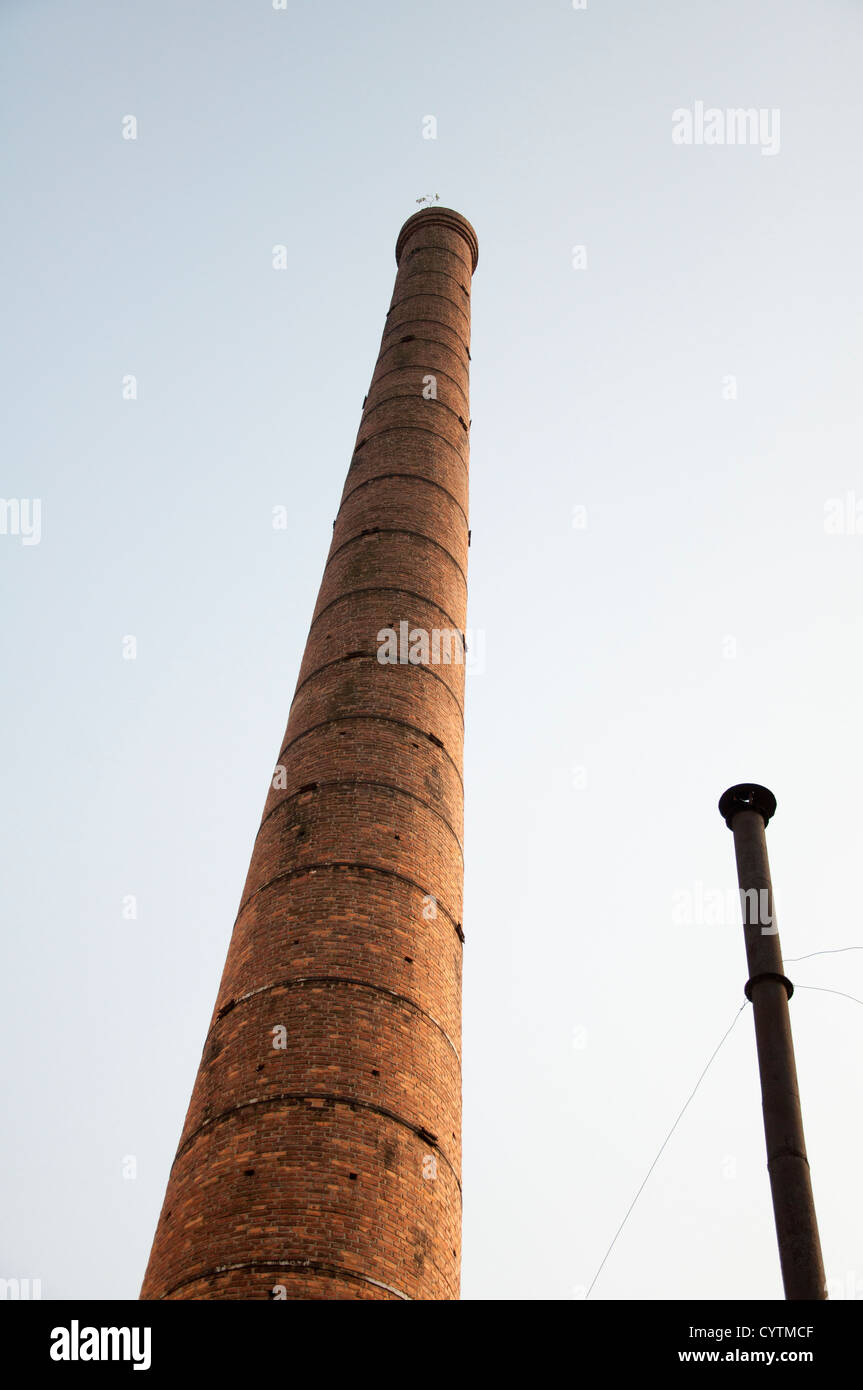 brick chimney and steel chimney Stock Photo Alamy