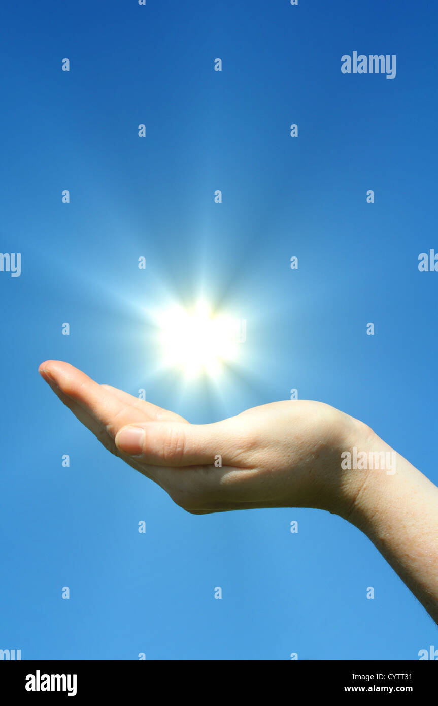 Sunshine Hand hand sun and blue sky with copyspace showing freedom or solar power ...