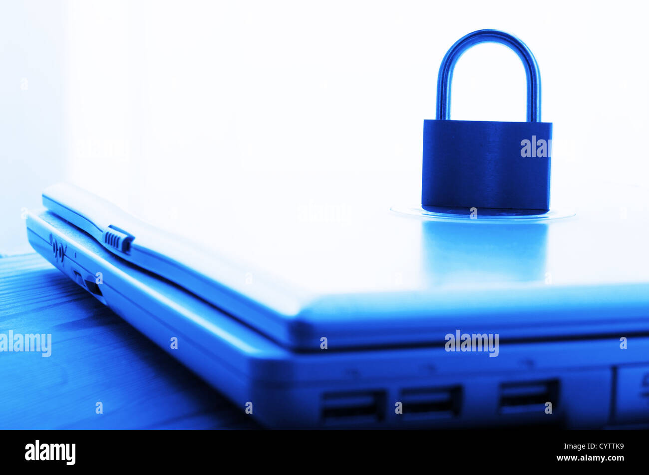 notebook and padlock showing internet or data security concept in blue Stock Photo