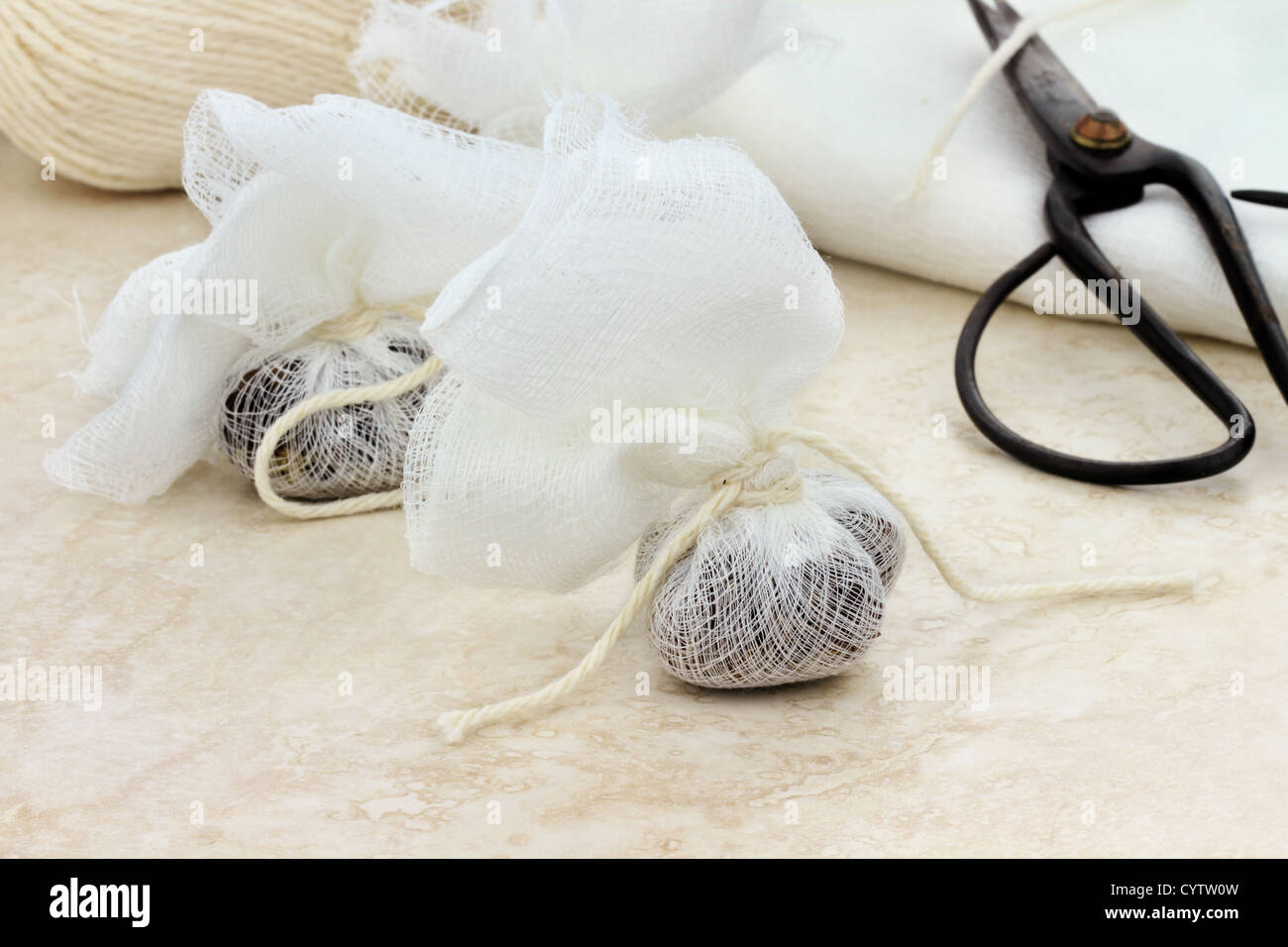 Muslin bag filled with herbs for tea or spices for a garni bag Stock