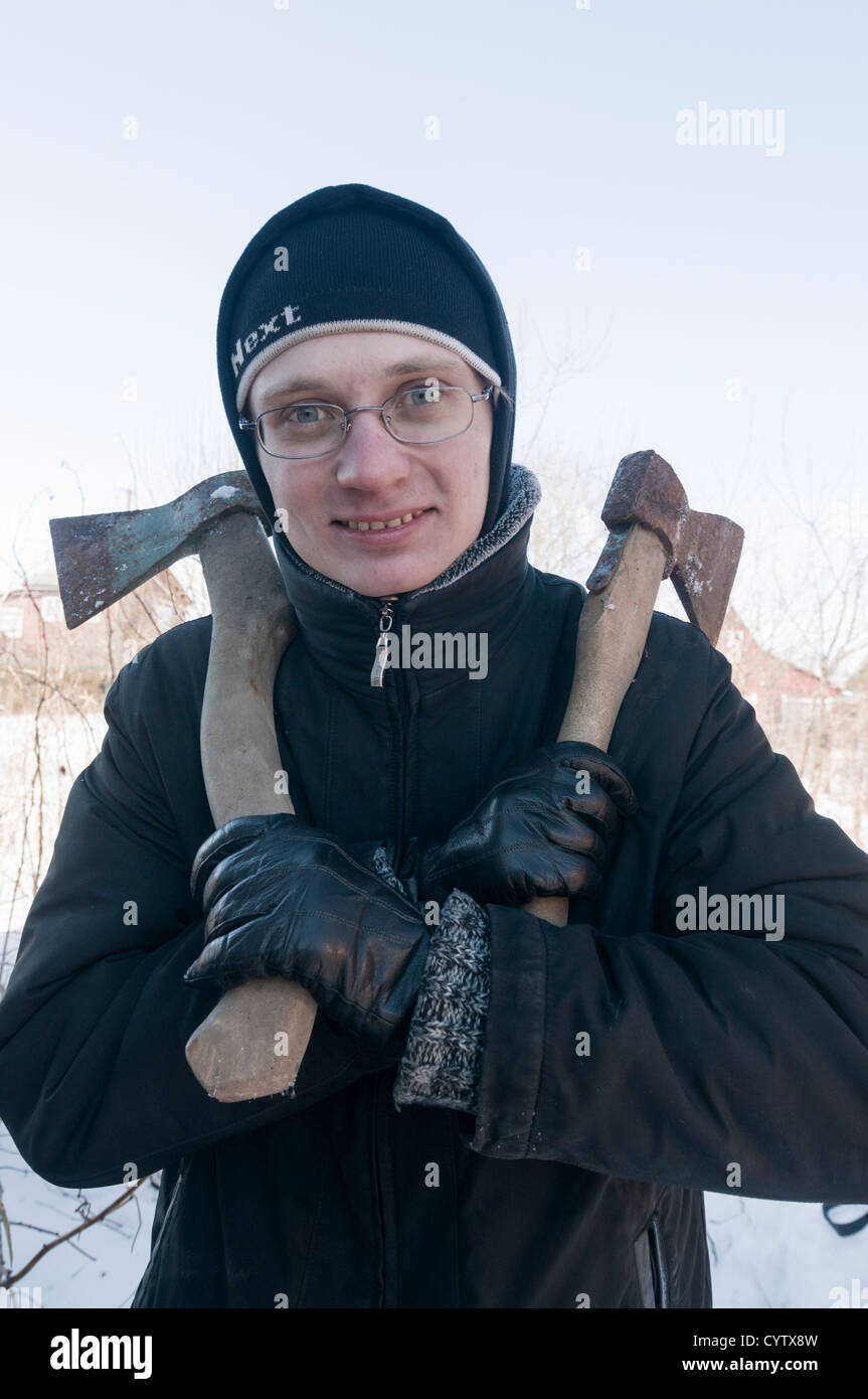 Individuals 20s day caucasian man snow cold axe Stock Photo