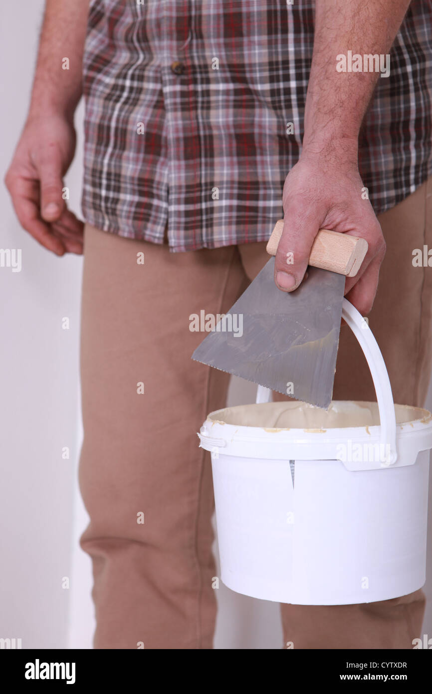 Man holding bucket of plaster and trowel Stock Photo Alamy